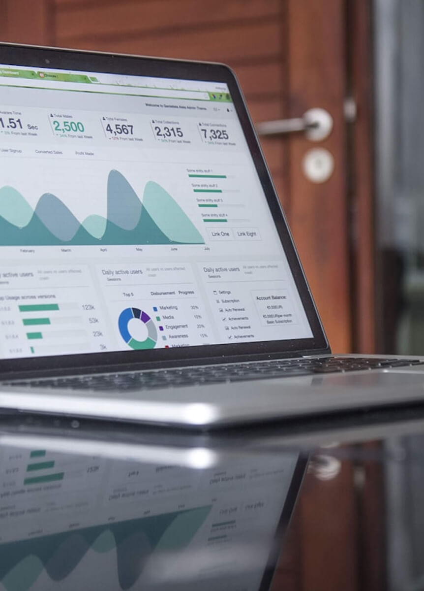 Laptop képernyőjén marketing analitikai irányítópult grafikonokkal